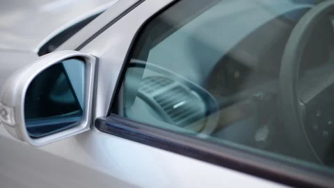 Close up of the mirror and the front window of a silver car Stock Footage 276630720
