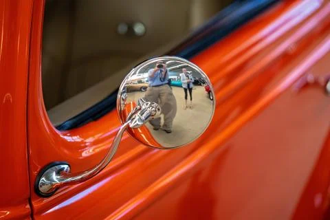 Close Up Of Mirror And Person Reflection On Orange Classic Car Stock Photos
