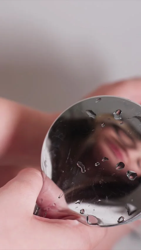 Close up Mirror Reflection with Water Droplets and Handheld Object with drops Stock Footage 346781032