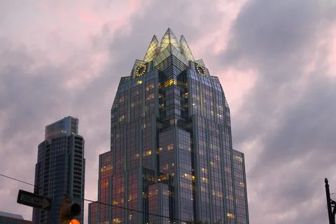Close up of a mirror skyscraper with pink clouds Stock Photos