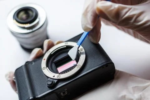 Close-up of mirrorless digital APS-C dirty camera matrix sensor cleaning Stock Photos