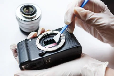 Close-up of mirrorless digital APS-C dirty camera matrix sensor cleaning Stock Photos