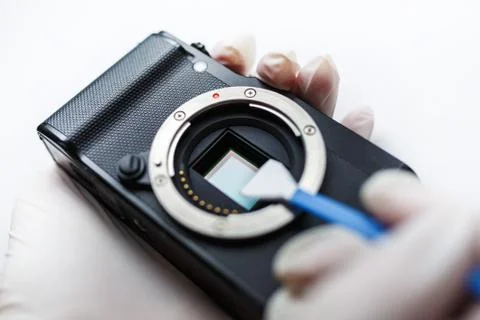 Close-up of mirrorless digital APS-C dirty camera matrix sensor cleaning Stock Photos