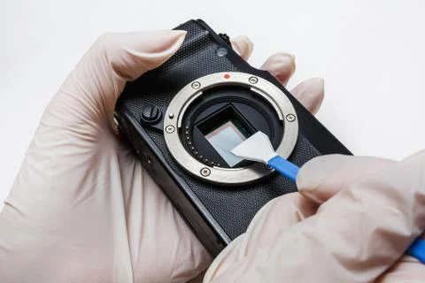 Close-up of mirrorless digital APS-C dirty camera matrix sensor cleaning Stock Photos