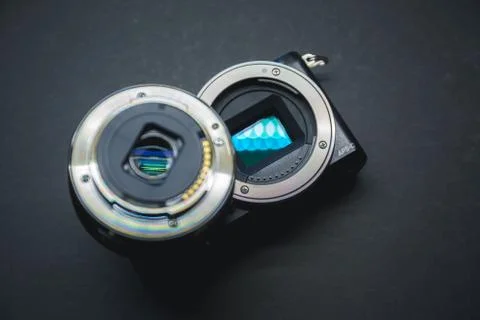 Close-up of mirrorless digital APS-C camera with deattached lens. Stock Photos