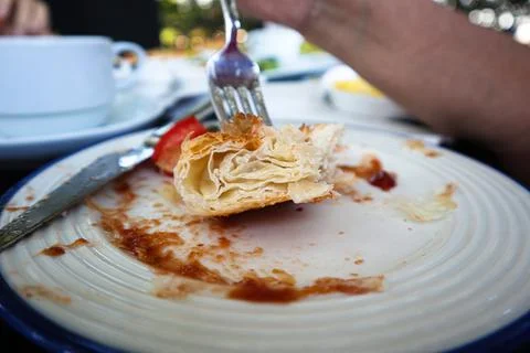 Close-up of missing bite on a bread with mayonaise on the fork on the morning Stock Photos