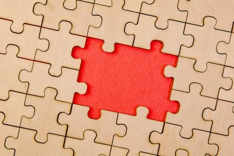 Close up of missing jigsaw puzzle piece with red space for text Stock Photos