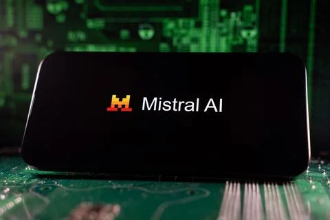Close up of Mistral AI logo on device with circuit board background. Toronto, Stock Photos
