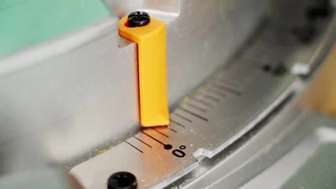 Close-up of a miter saw angle adjustment with an orange pointer 스톡 동영상 301637396