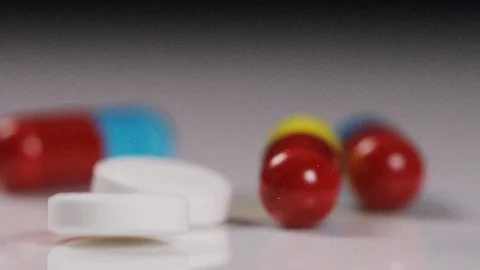 Close up of mix of different medication falling in slow motion Stock Footage 70373443