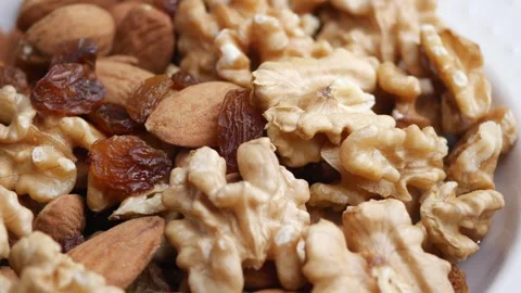 Close up of mixed nuts and raisins in bowl showing healthy eating and natur.. Stock Footage 332893036