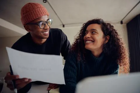 Close up of mixed race couple using laptop for online banking. Happy African Stock Photos
