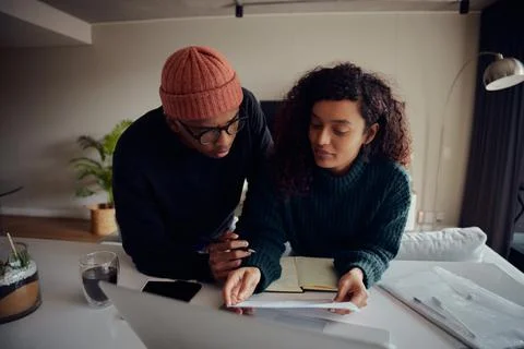 Close up of mixed race couple using laptop for online banking. Happy African Stock Photos