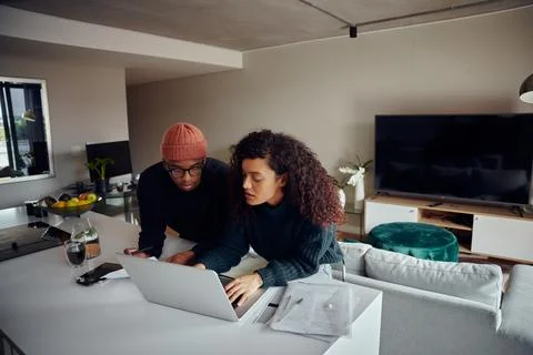 Close up of mixed race couple using laptop for online shopping. Happy African Stock Photos