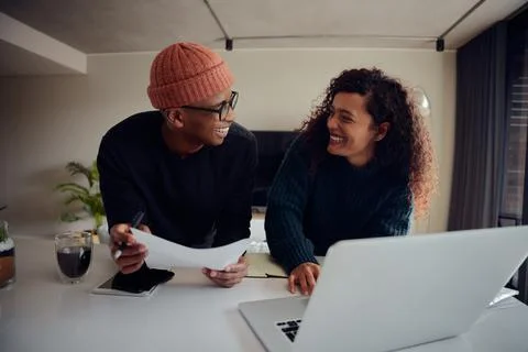Close up of mixed race couple using laptop for online banking. Happy African Stock Photos