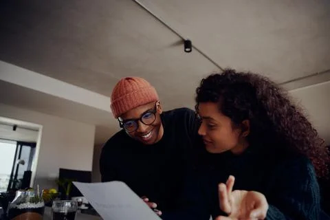 Close up of mixed race couple using laptop for online banking. Happy African Stock Photos