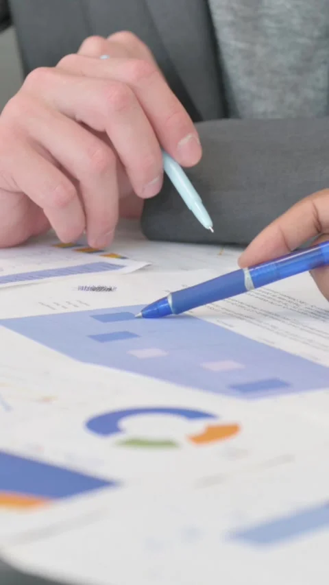 Close up of Mixed Race Hands Working on Documents, vertical video Stock Footage 324713534