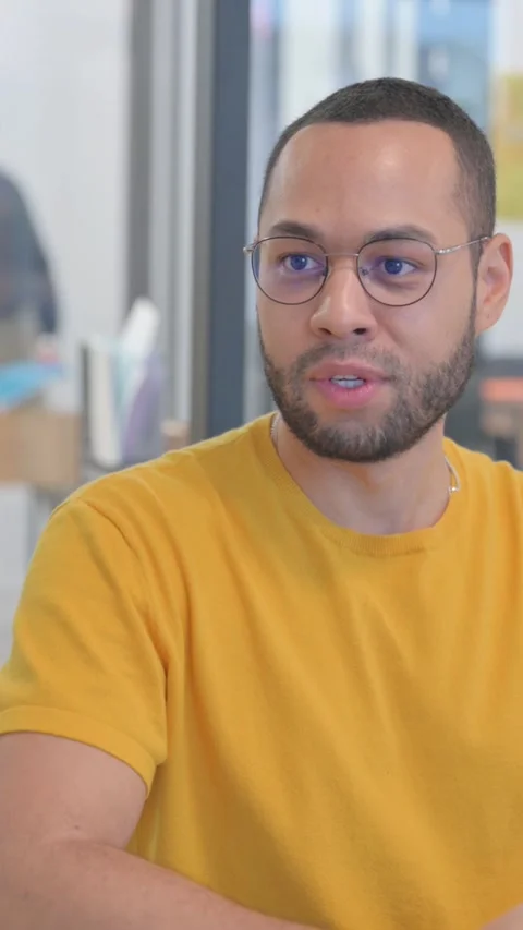 Close up of Mixed Race Man Talking with Creative Teammate, vertical video Video stock 325563604