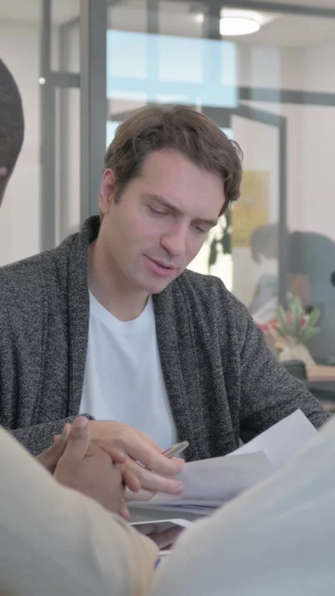 Close up of Mixed Race Team Talking in Meeting, vertical video Video stock 324795501