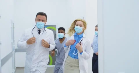 Close up of mixed-races doctors, nurses and paramedics in medical masks running Stock Footage 144604184