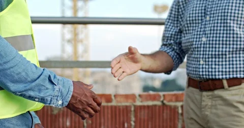 Close up of mixed-races men hands shaking outdoors at building. Spreading of Stock Footage 128433815