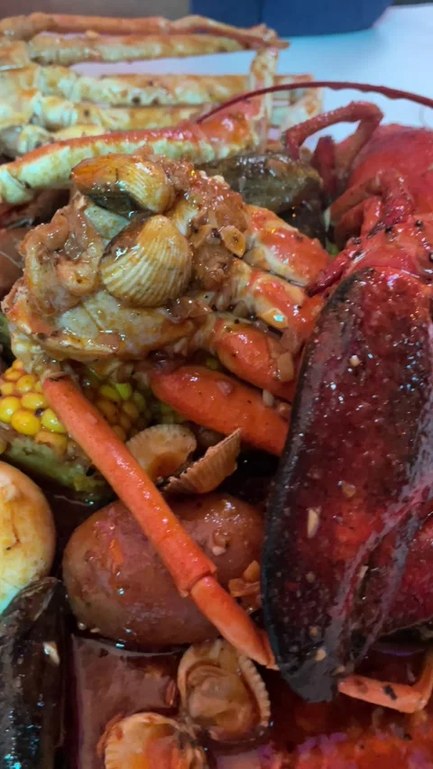 A close-up of mixed seafood pouring on the table, travel life, experience Video stock 255227149