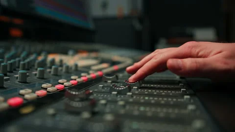 Close-up of mixer console hand adjusting faders A sound engineer works in the Stock Footage 237975647