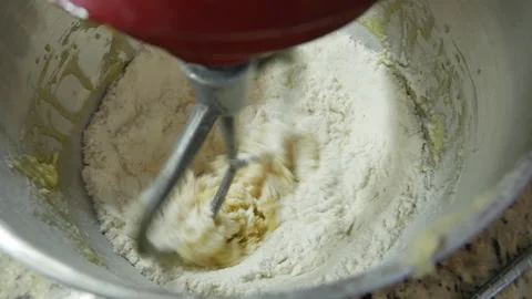 Close up with mixer doing dough Stockbeeldmateriaal 166529892