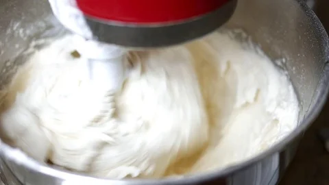 Close up of Mixer stirring cake batter Stock Footage 83014479