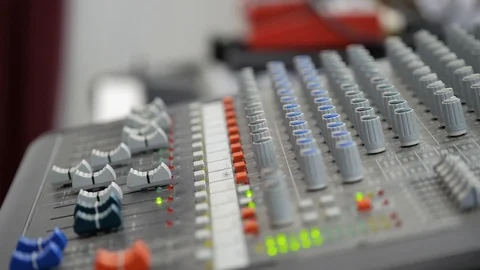 Close-up. Mixing console. Equalizer. In the background man plays the synthesizer Stock-Footage 126921994