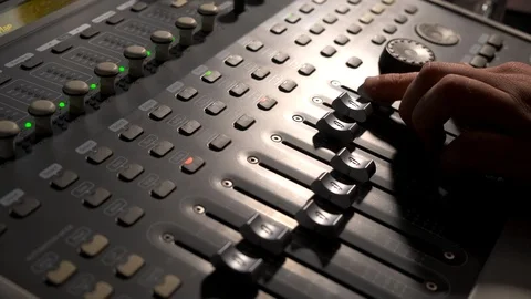 Close-up of a mixing console, the hand adjusts the faders. Sound director works Stock Footage 125633729