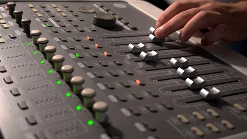 Close-up of a mixing console, the hand adjusts the faders. Sound director works Stock Footage 125633951