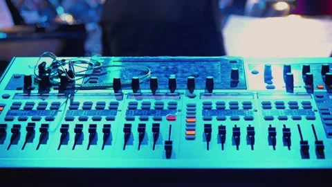 Close-up of a mixing console illuminated by blue light. Various switches Video stock 309674103