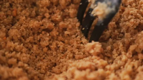 Close up of mixing dough with fork for baking apple crumble cake at home Stock Footage 128587212