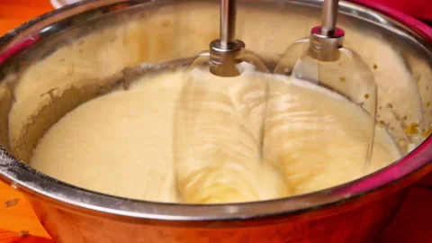 Close-up mixing sugar and egg with an electric mixer for homemade cookies batter Stock Footage 158659655