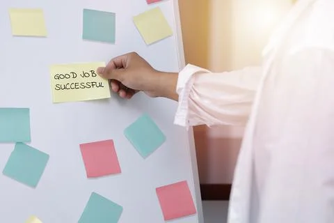 Close up mn hand taking  yellow sticky note on the whiteboard. Reminder plann Stock Photos