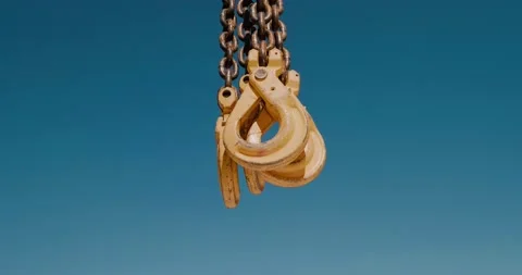 Close-up of mobile crane hooks. Hooks on chains against blue sky Stock Footage 136527222