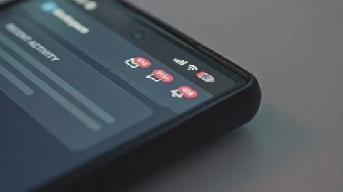 Close up of mobile phone display showing red alert counters growing fast, Stock Footage 341569596