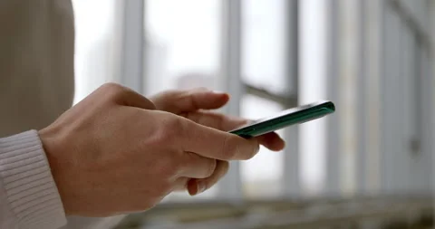 Close-up of a mobile phone in hands. Using a smartphone to chat online. Stock Footage 143725152