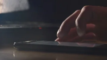Close Up of mobile phone lying on the table and man hands nervously surfing the Stock Footage 85517141