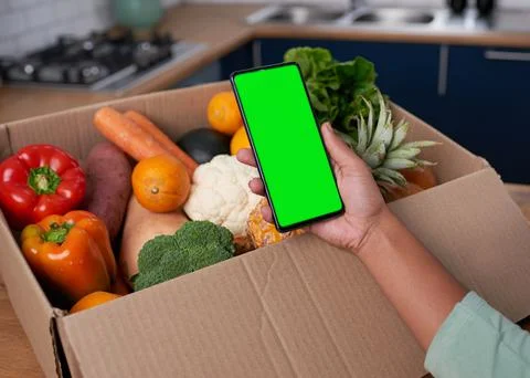 A close up of mobile phone screen with vegetable box delivery - chroma key Stock Photos