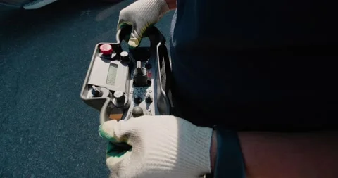 Close-up of a mobile radio remote control panel in the hands of a crane operator Stock Footage 136527257