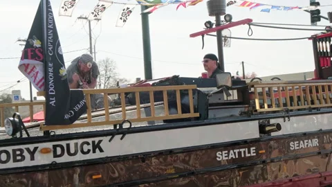 Close-up of the Moby Duck pirate ship float with costumed Seafair  sammer egg 34 Stock Footage 339530213