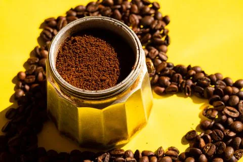 Close-up of mocha coffee maker with ground coffee and surrounded by coffee be Stock Photos