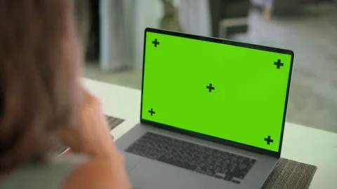 Close up of mock up green screen of modern aluminium laptop on table Stock Footage