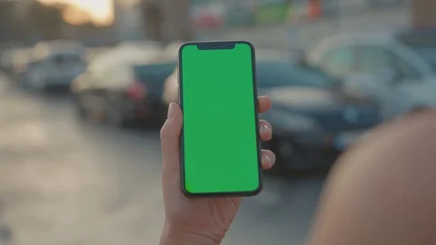 Close-up mock-up modern vertical smartphone with greenscreen in human hand Video stock 117551593