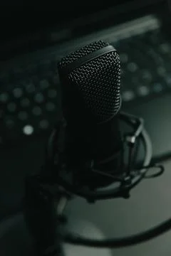 Close up mock up of a streaming microphone with a laptop with copy space, t.. Fotos Stock