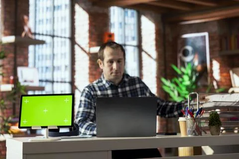 Close up of mockup electronic device next to employee checking paperwork Foto stock