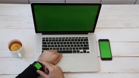 Close up Mockup of Man working on Laptop, Smartphone, Watch with Green Screen. Stock Footage 116613928