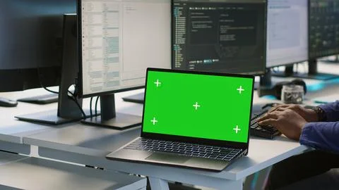 Close up of mockup notebook on desk next to workers coding in data center Stock Photos